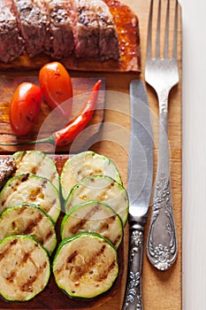 Delicious beef steak with vegetable over wooden table