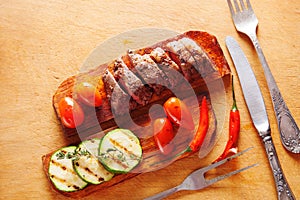 Delicious beef steak with vegetable over wooden table