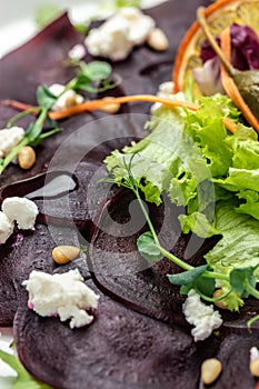 Delicious beetroot carpaccio with feta, vertical image. top view