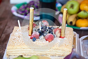 Delicious berry cake with two candles