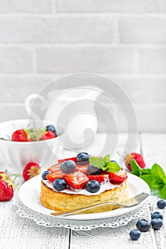 Delicious berry cheesecake with fresh strawberry and blueberry on white background