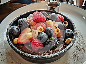 Delicious berry fruit chocolate tart focused on the berries in the middle.