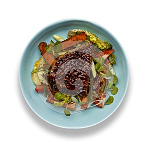 A delicious bowl of BBQ rump steak, sweet potatoe chips and vegetables, in a light blue bowl isolated on white