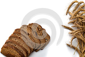 Delicious bread. Fresh loaf of rustic traditional bread with wheat grain ear or spike plant isolated on white background. Rye