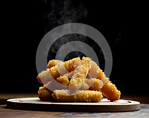 Delicious breaded mozzarella cheese sticks stack with hand with hot smokes photo