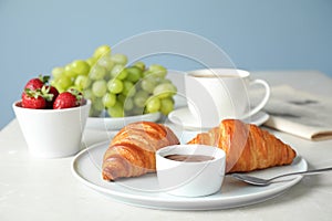 Delicious breakfast with croissants and chocolate served on table