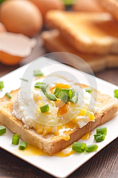 Delicious breakfast. Eggs benedict with ham on toast.