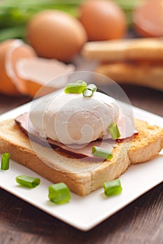 Delicious breakfast. Eggs benedict with ham on toast.