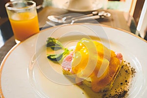 delicious breakfast of eggs benedict on table