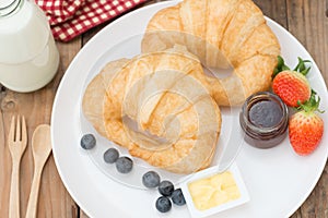 Delicious breakfast with fresh croissants and butter, jam.