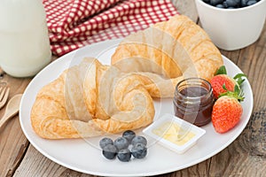 Delicious breakfast with fresh croissants and butter, jam.