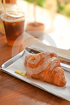 Delicious breakfast with fresh croissants and coffee served with butter