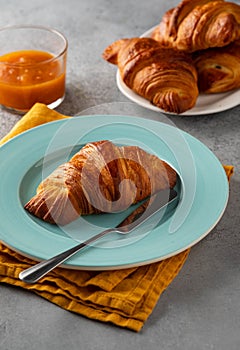 Delicious breakfast with fresh croissants and jam served with butter