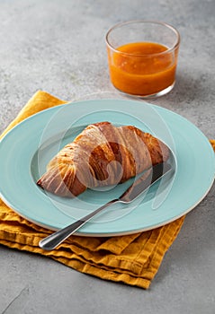 Delicious breakfast with fresh croissants and jam served with butter