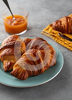 Delicious breakfast with fresh croissants and jam served with butter