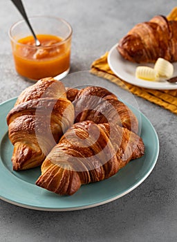 Delicious breakfast with fresh croissants and jam served with butter