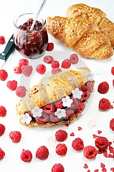 Delicious breakfast with fresh croissants and ripe berries