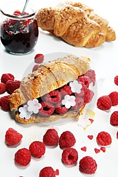 Delicious breakfast with fresh croissants and ripe berries