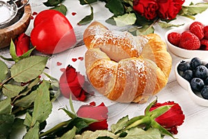 Delicious breakfast with fresh croissants and ripe berries and mint for valentines day