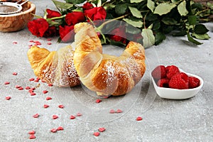 Delicious breakfast with fresh croissants and ripe berries and mint for valentines day