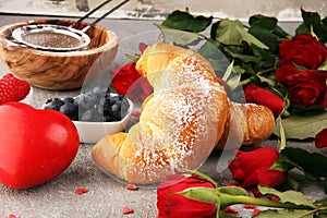 Delicious breakfast with fresh croissants and ripe berries and mint for valentines day