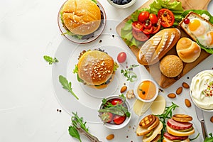 Delicious breakfast spread with cheeseburgers, fresh salad, bread rolls, and soft-boiled eggs on a white background. A