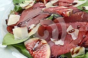 Delicious bresaola salad on plate, closeup view