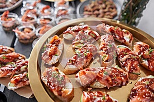 Delicious bruschetta with salmon and canape shrimp on table. Tasty buffet table. Summer party. Catering concept