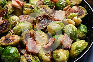 Delicious Brussels sprouts with bacon in pan, closeup photo