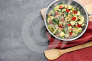 Delicious Brussels sprouts with bacon in pan on table, top view. Space for text
