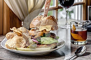 Delicious Burger with Cocktail and Wine on Table