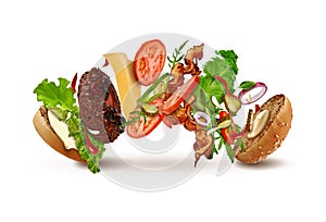 Delicious burger with flying ingredients isolated on white. Ham, beef cutlet, cheese, mayonnaise, ketchup, vegetables