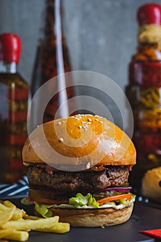 Delicious burger with organic cutlet with fried potatoes.