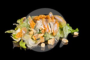 Delicious caesar salad with crispy chicken and lettuce with reflection