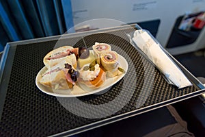 Delicious canape finger food appetizers served on airplane business class seats.