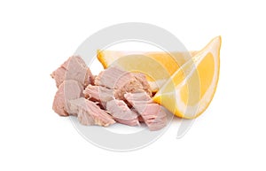 Delicious canned tuna chunks with lemon isolated on white