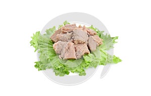 Delicious canned tuna chunks with lettuce isolated on white