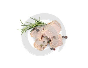 Delicious canned tuna chunks with rosemary and peppercorns isolated on white, top view