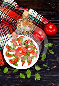 Delicious caprese salad with tomatoes and mozzarella cheese with