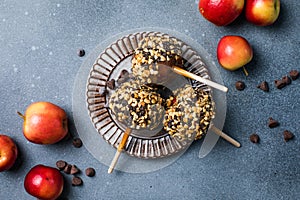 delicious carmel candy apples with covered in chopped nuts