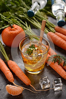 Delicious carrot and mandarin cocktail with ice