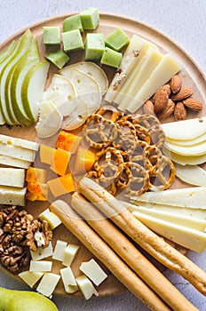 Delicious cheese mix with grapes, jam, snacks, crackers, walnuts