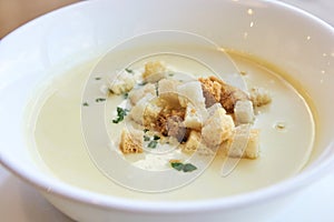 Delicious cheese soup. Small crackers. White dishes