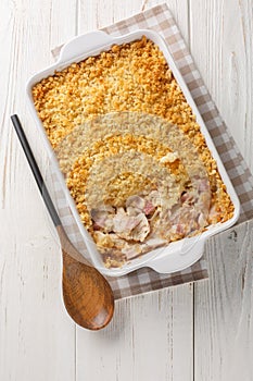 Delicious chicken cordon bleu casserole used rotisserie chicken, ham, and a creamy cheese sauce close up in the baking dish on the