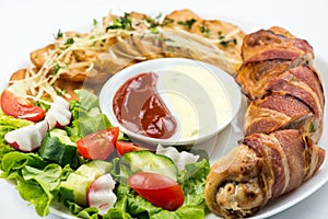 Delicious Chicken rolls with cheese and bacon on a plate close-up. horizontal