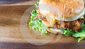 Delicious chicken sandwich on wood tray photo