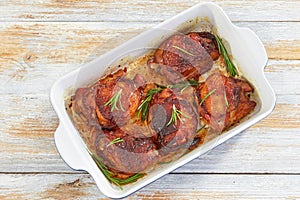 Delicious chicken thigh roasted in rectangular baking dish photo