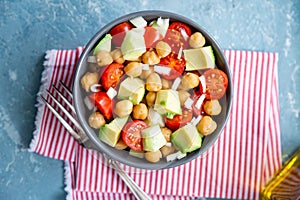 Delicious chickpea salad with cherry tomato, avocado and cucumber photo