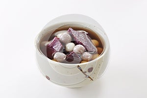 Delicious Chinese dessert, purple potato taro ball syrup .on white background