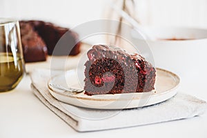 Delicious chocolate cake brownie with cherries on white wooden table